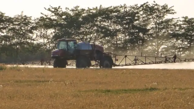 farmer applying fertilizer in field