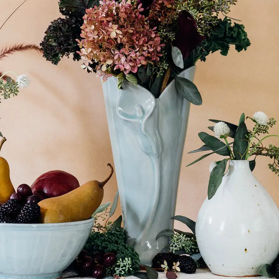 lily vase beside fruit bowl